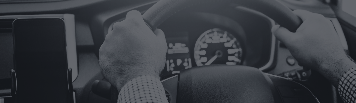Mobile phone mounted in a car next to a driver