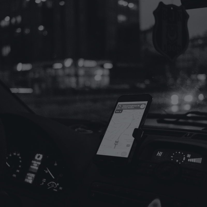 A phone mounted to the front dashboard of a car